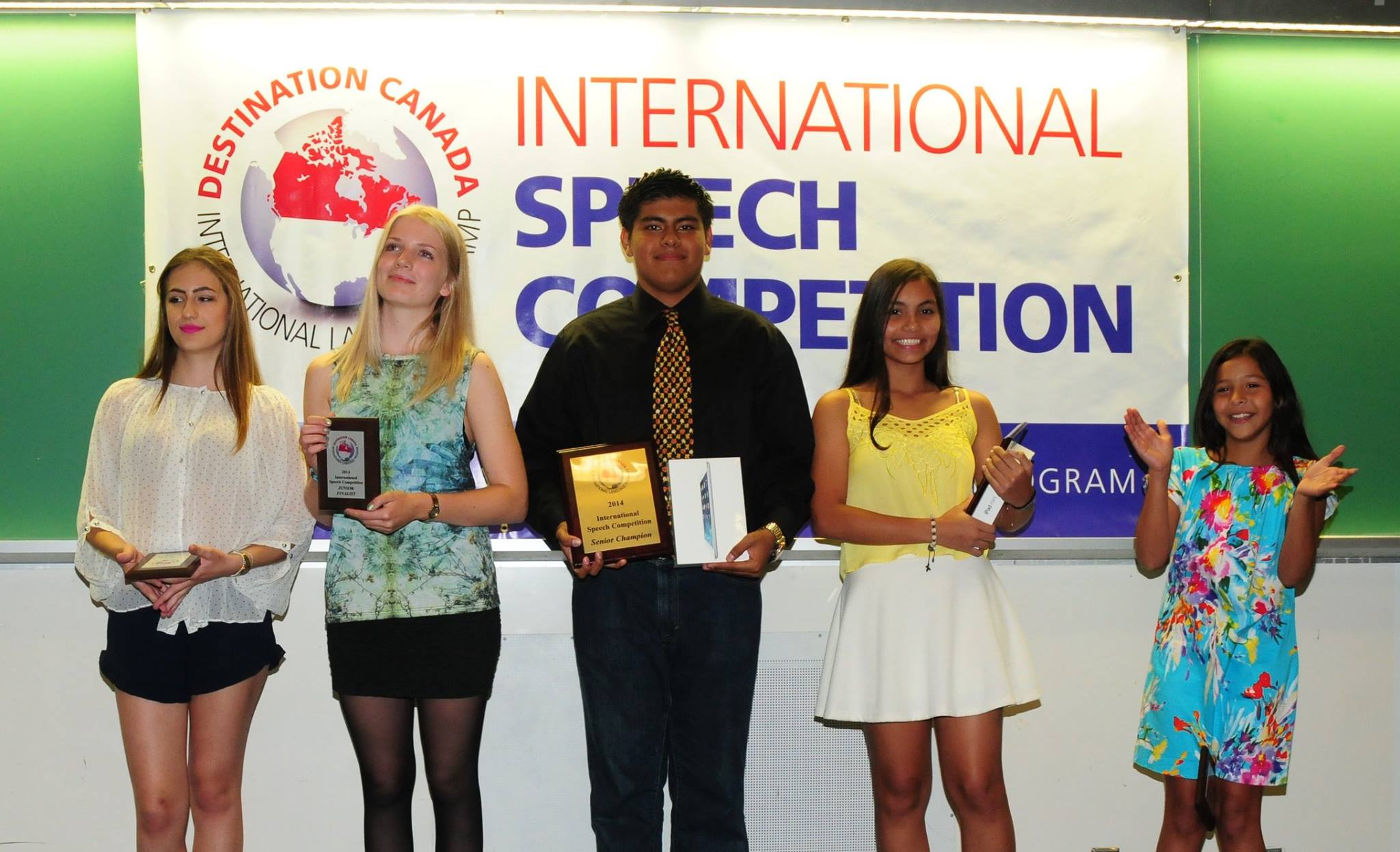 Winners stand with their certificates & prizes at Destination Canada's International Speech Competition